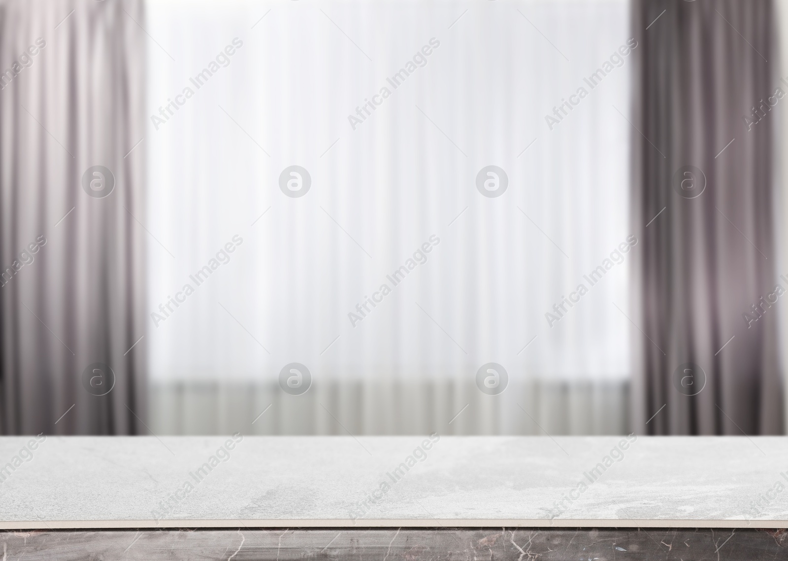 Empty stone table against window with curtains in room Image of Empty stone table against window with curtains in room