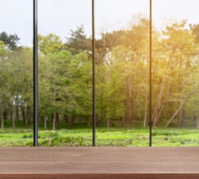 Image of Empty wooden table against window in room