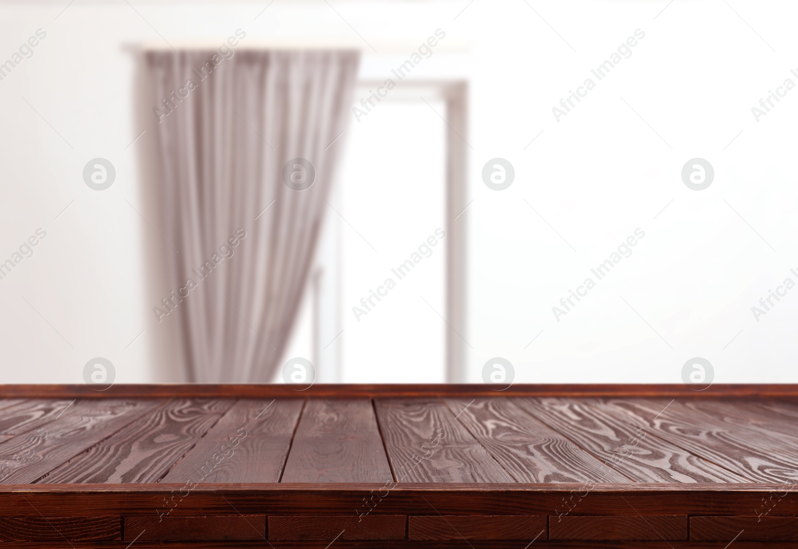 Image of Empty wooden table against window with curtain in room