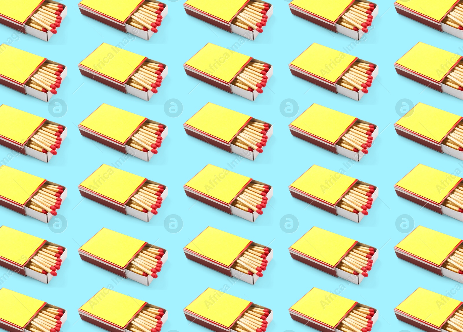 Cardboard box with matches on light blue background, pattern design Image of Cardboard box with matches on light blue background, pattern design