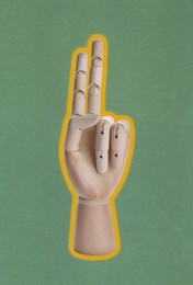 Image of Wooden hand model on dark green background
