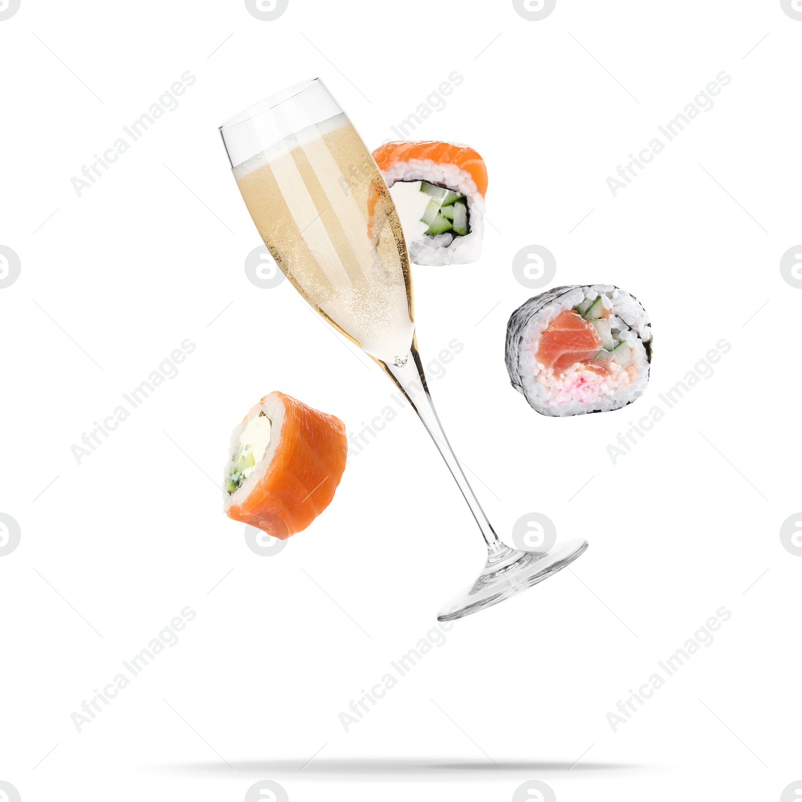 Image of Sparkling wine in glass and sushi rolls falling on white background