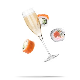 Image of Sparkling wine in glass and sushi rolls falling on white background