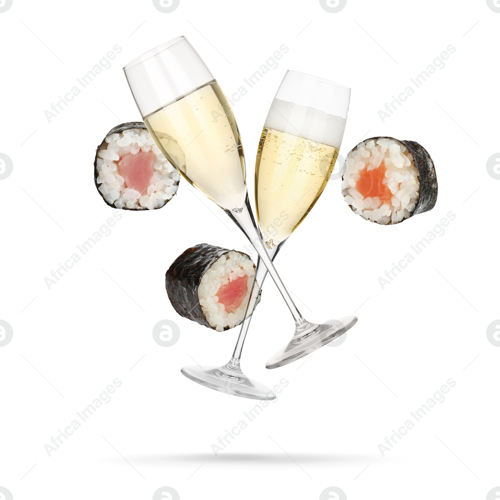 Sparkling wine in glasses and sushi rolls falling on white background Image of Sparkling wine in glasses and sushi rolls falling on white background