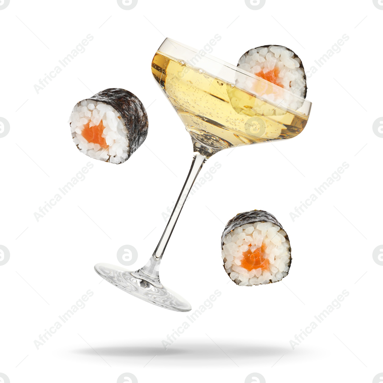 Sparkling wine in glass and sushi rolls falling on white background Image of Sparkling wine in glass and sushi rolls falling on white background