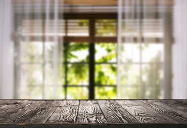 Image of Empty wooden table against window with curtains in room
