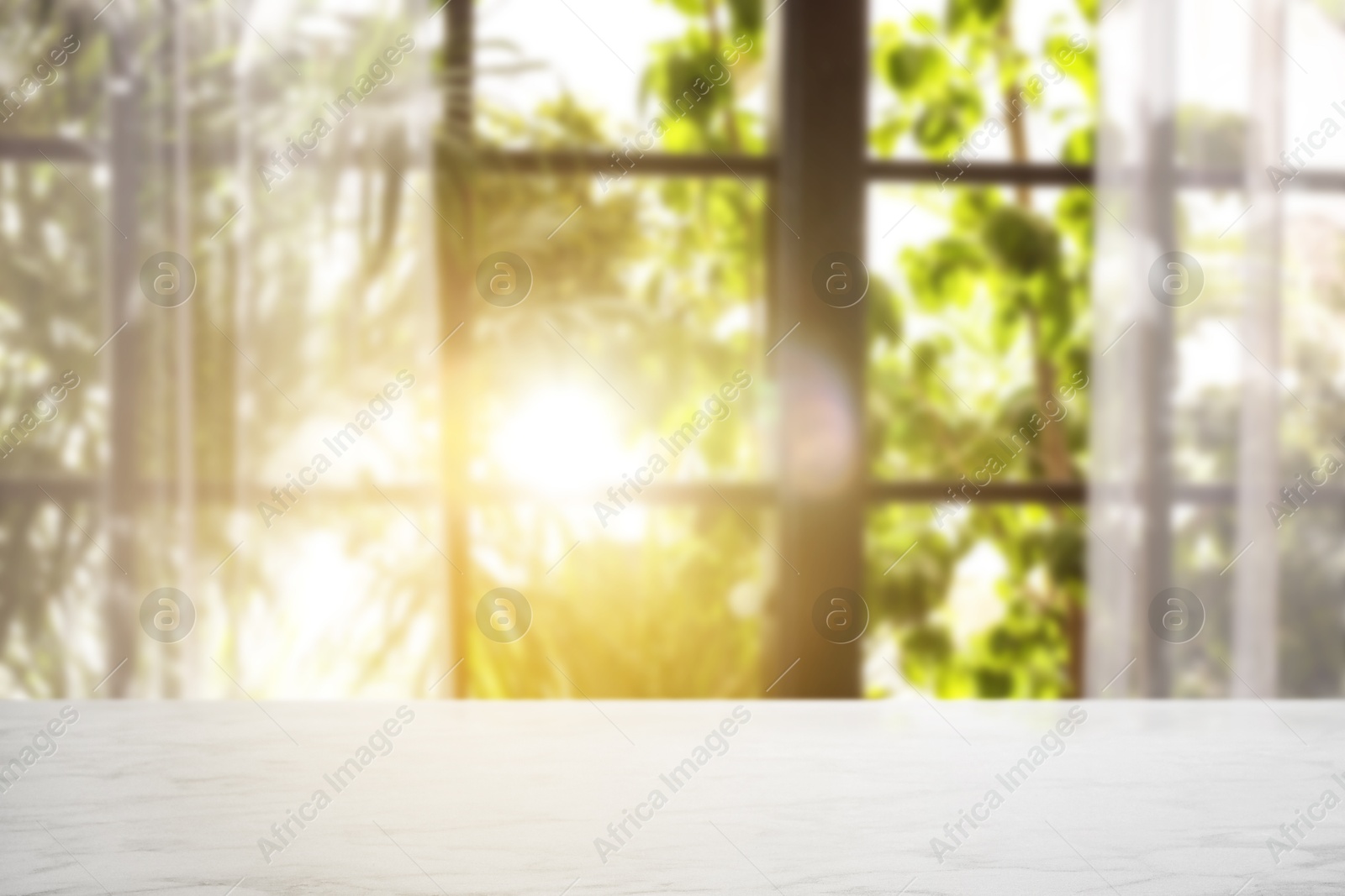 Image of Empty white table against window with curtains in room