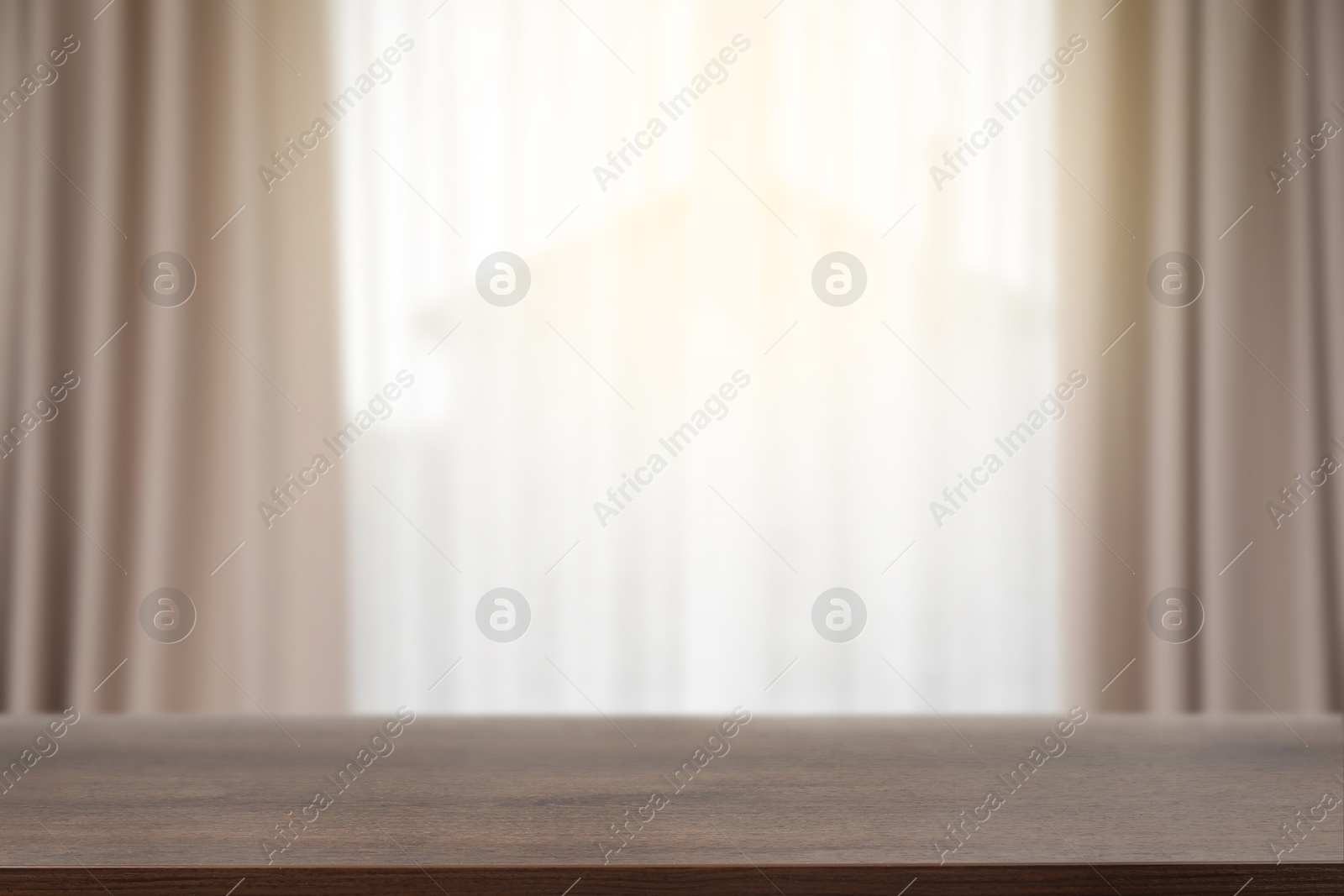 Image of Empty wooden table against window with curtains in room