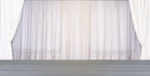 Image of Empty grey wooden table against windows with curtains in room, banner design