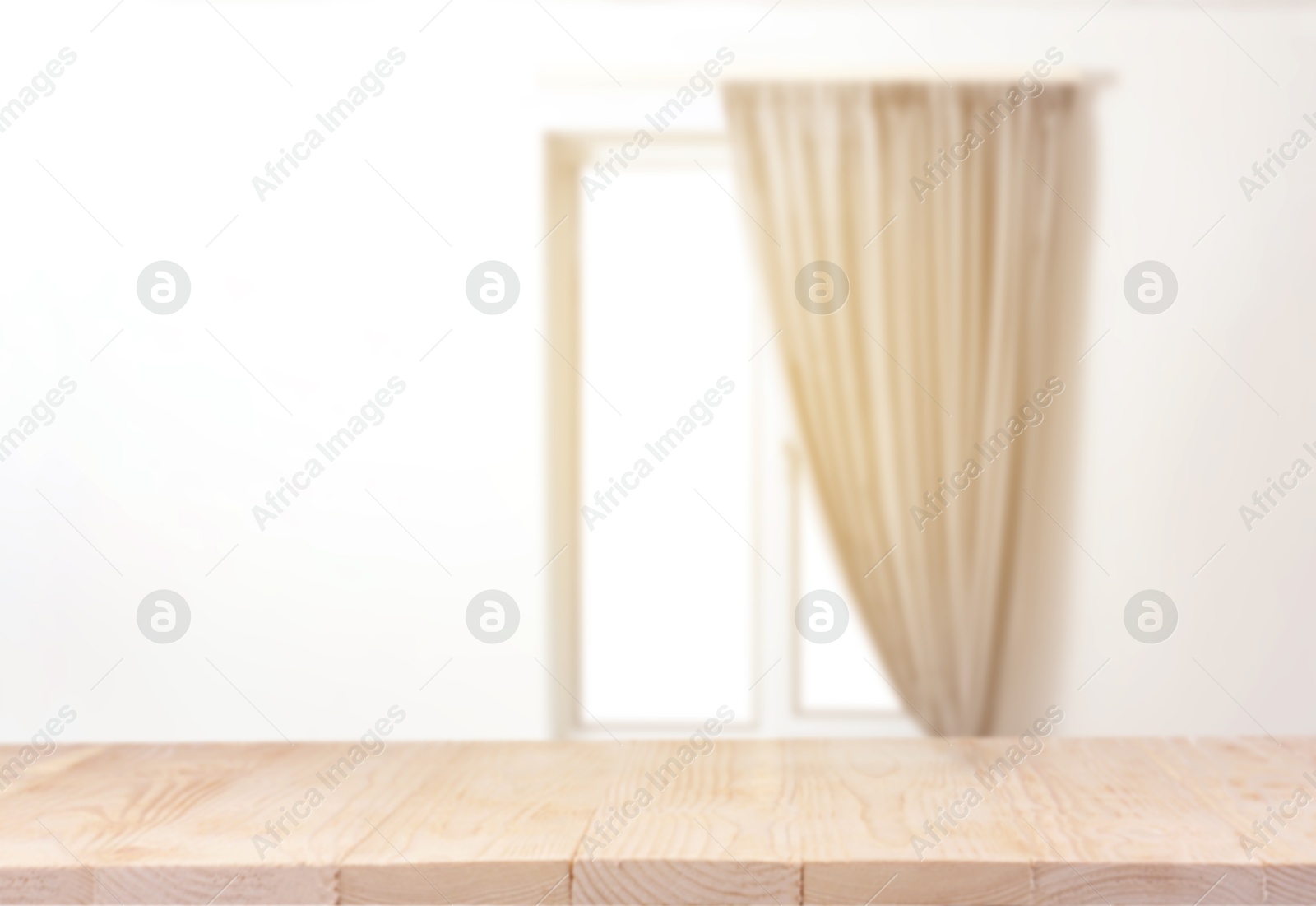 Image of Empty wooden table against window with curtain in room