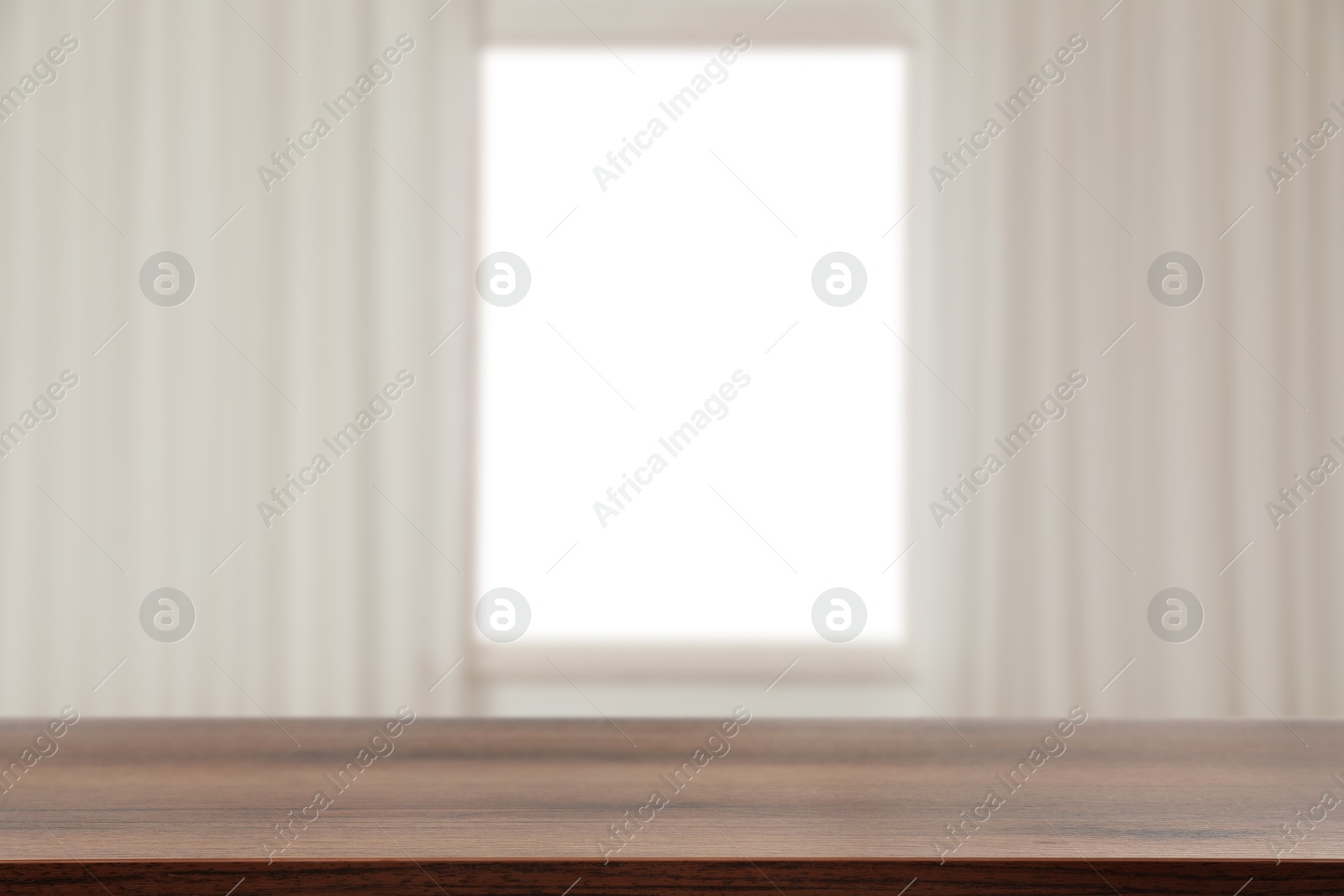 Image of Empty wooden table against window with curtains in room