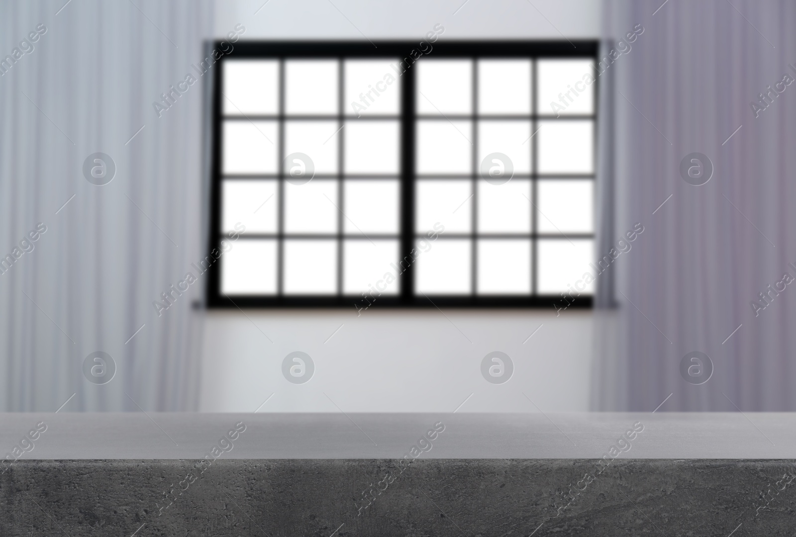 Image of Empty grey table against window with curtains in room