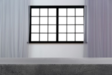 Image of Empty grey table against window with curtains in room