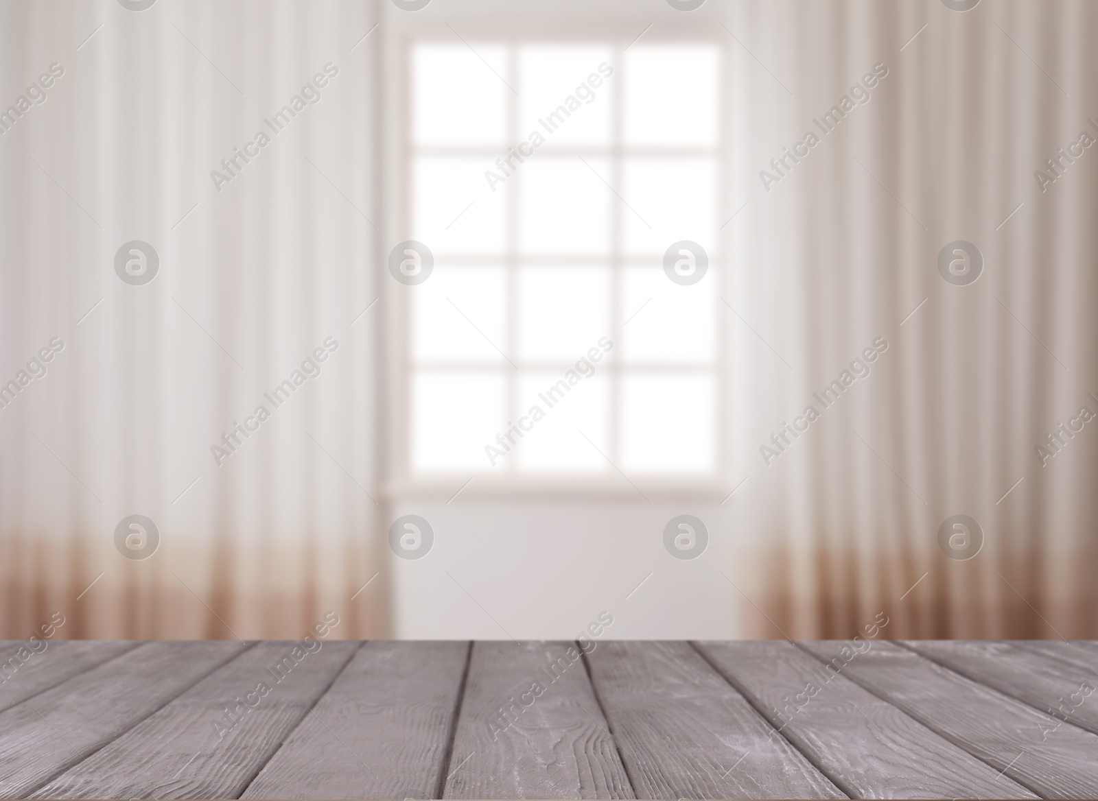 Image of Empty wooden table against window with curtains in room