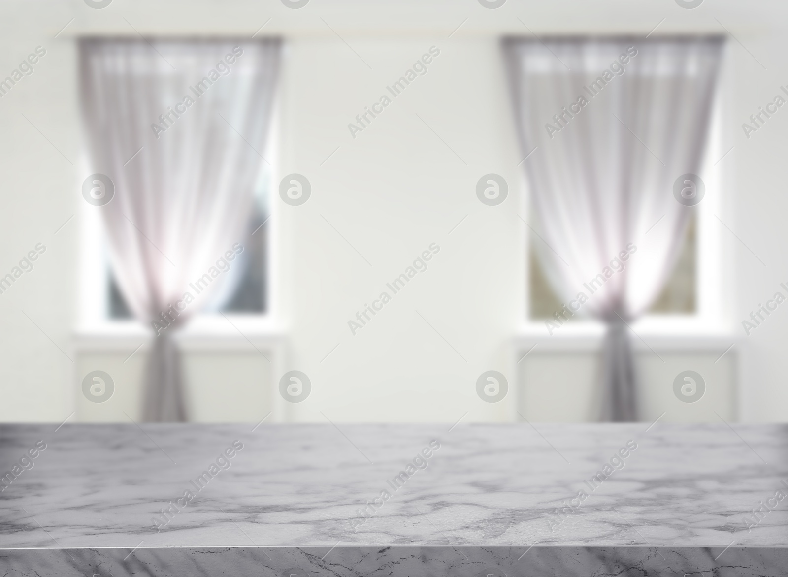 Image of Empty marble table against windows with curtains in room