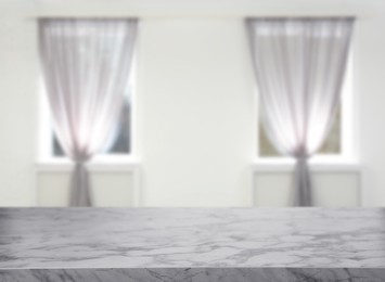 Image of Empty marble table against windows with curtains in room