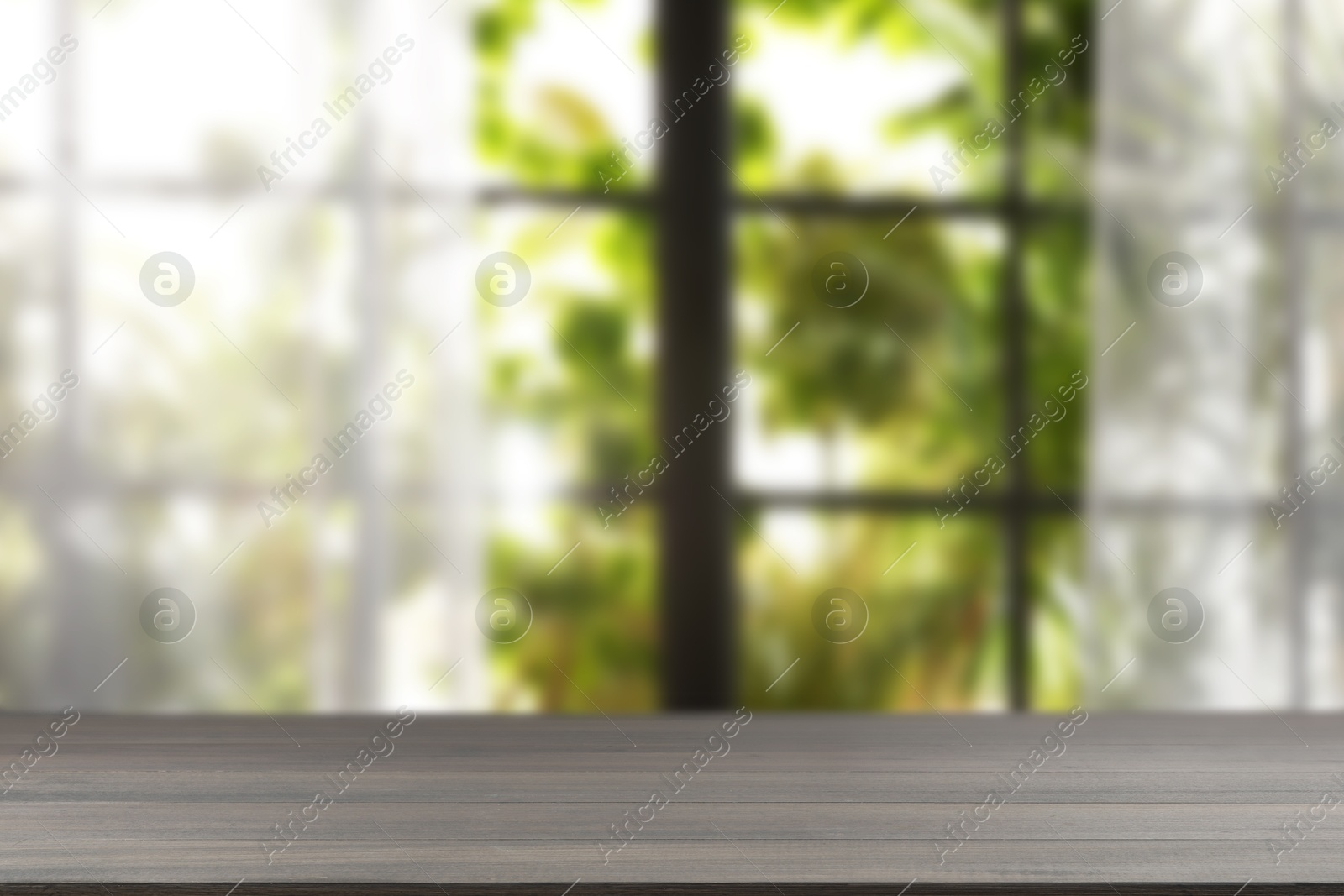 Image of Empty wooden table against window with curtains in room