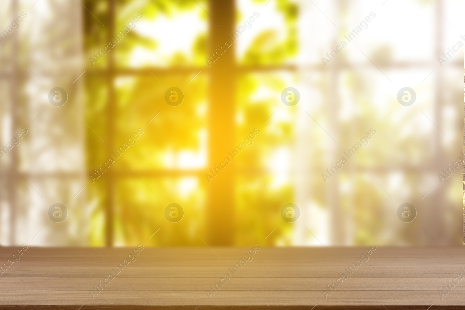 Image of Empty wooden table against window with curtains in room