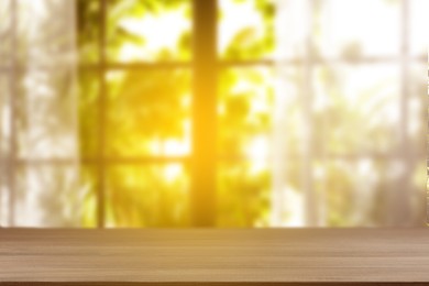 Image of Empty wooden table against window with curtains in room