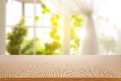 Image of Empty wooden table against window with curtain in room