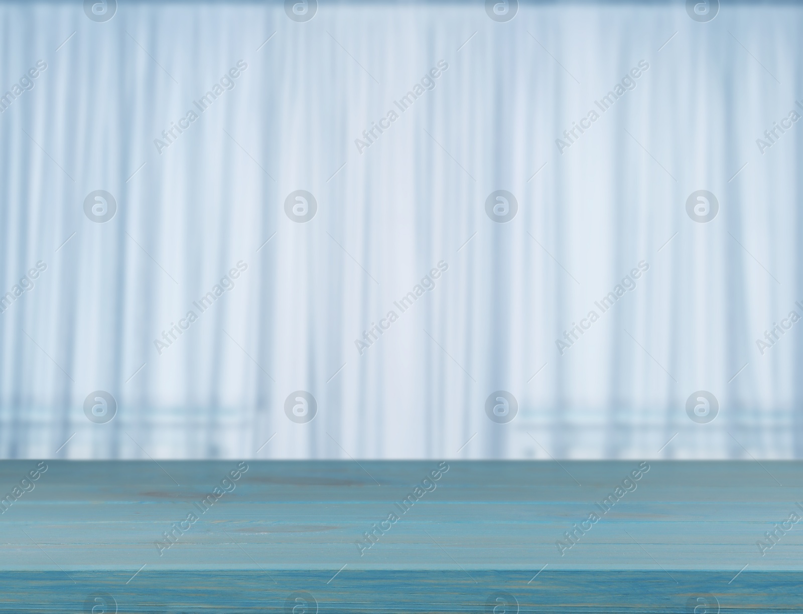 Empty wooden table against window with curtains in room Image of Empty wooden table against window with curtains in room