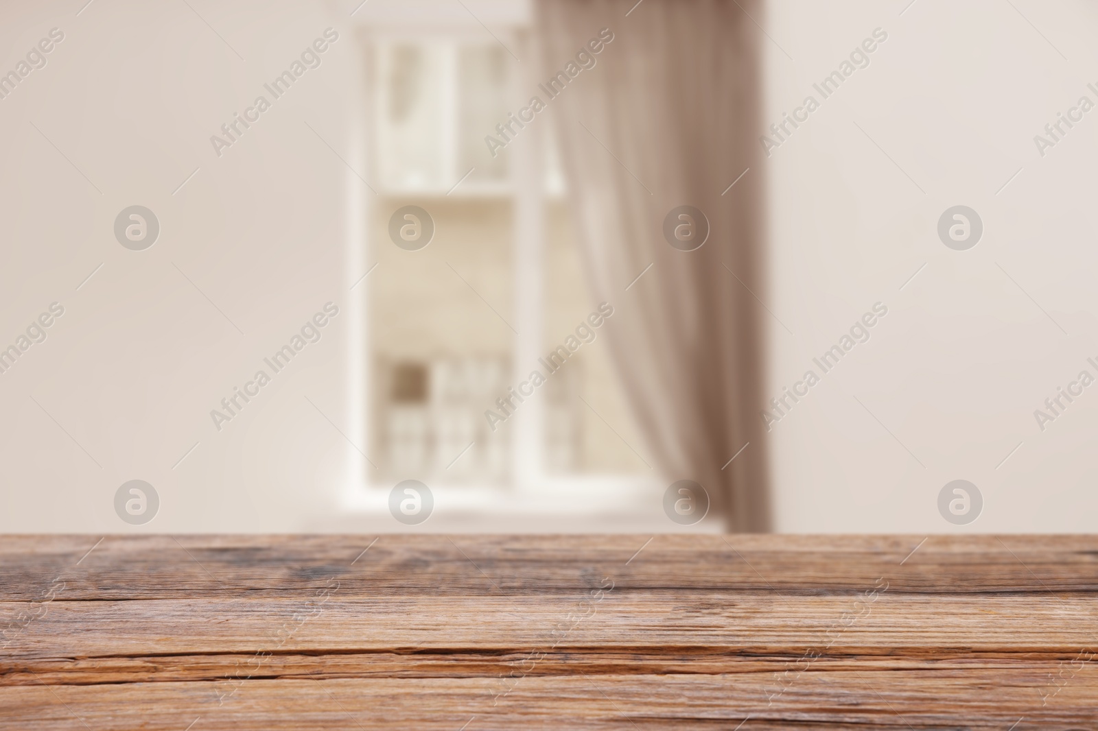 Empty wooden table against window with curtain in room Image of Empty wooden table against window with curtain in room