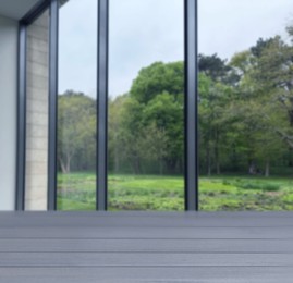 Image of Empty wooden table against window in room