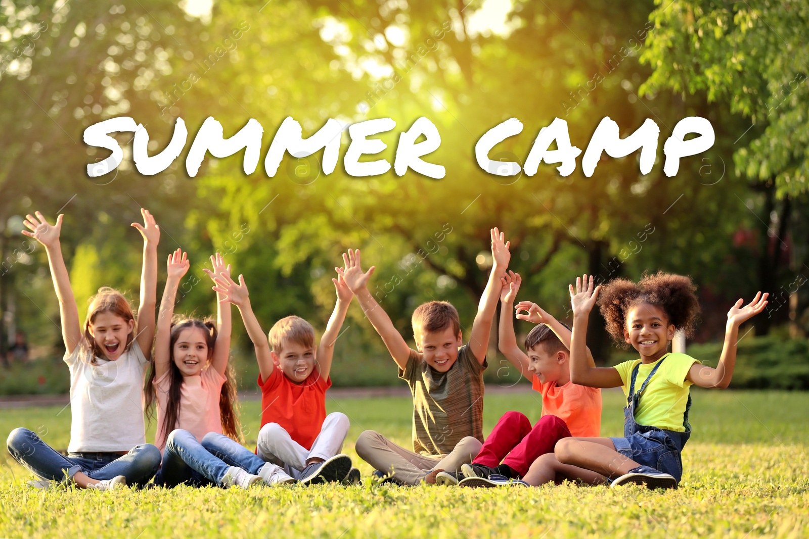 Summer camp, seasonal vacation. Cute children sitting on grass outdoors on sunny day Image of Summer camp, seasonal vacation. Cute children sitting on grass outdoors on sunny day