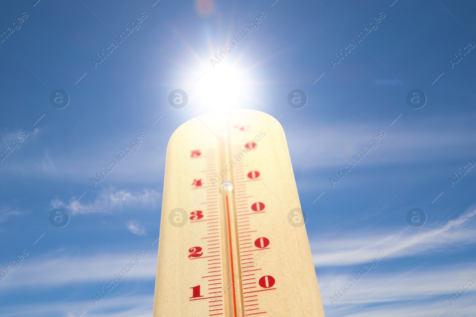 Image of High temperature on thermometer against blue sky on sunny day. Summer weather