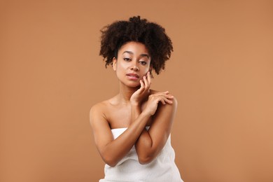 Photo of Portrait of beautiful Brazilian woman after spa treatment on light brown background