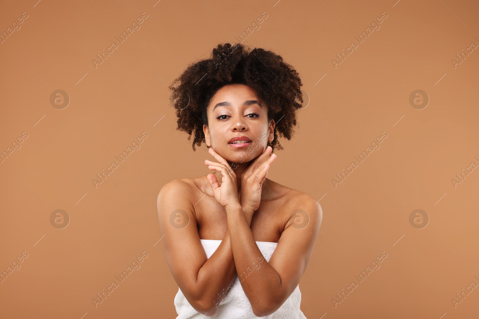 Portrait of beautiful Brazilian woman after spa treatment on light brown background Photo of Portrait of beautiful Brazilian woman after spa treatment on light brown background