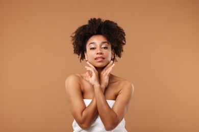 Photo of Portrait of beautiful Brazilian woman after spa treatment on light brown background