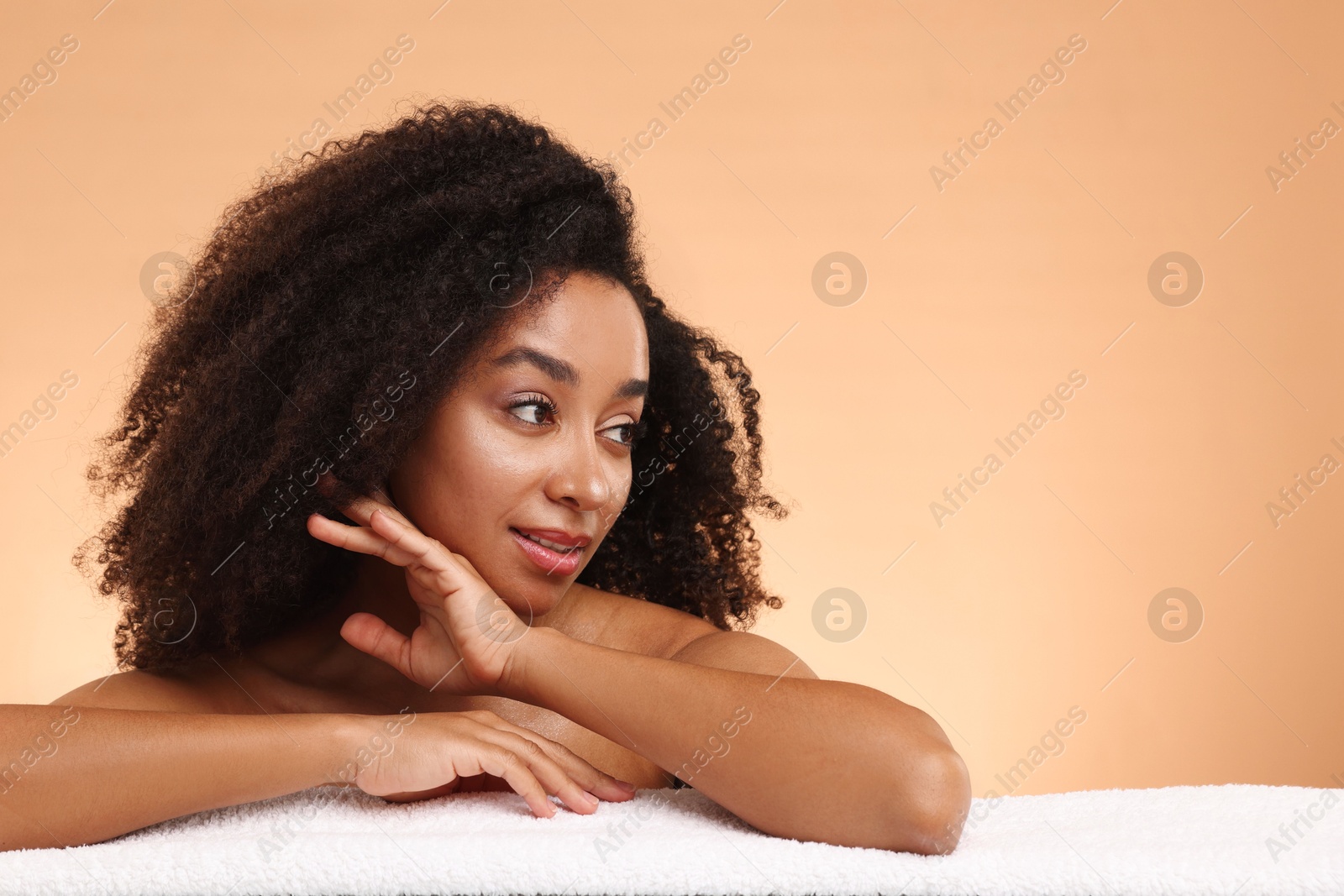 Portrait of beautiful Brazilian woman with towel after spa treatment on beige gradient background. Space for text Photo of Portrait of beautiful Brazilian woman with towel after spa treatment on beige gradient background. Space for text