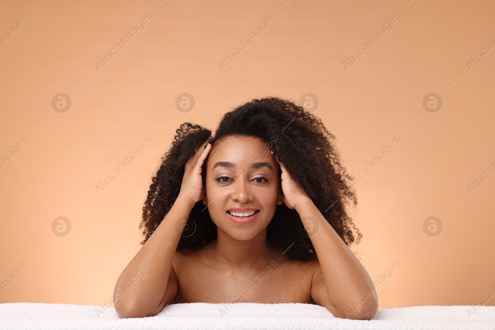 Portrait of beautiful Brazilian woman with towel after spa treatment on beige gradient background Photo of Portrait of beautiful Brazilian woman with towel after spa treatment on beige gradient background
