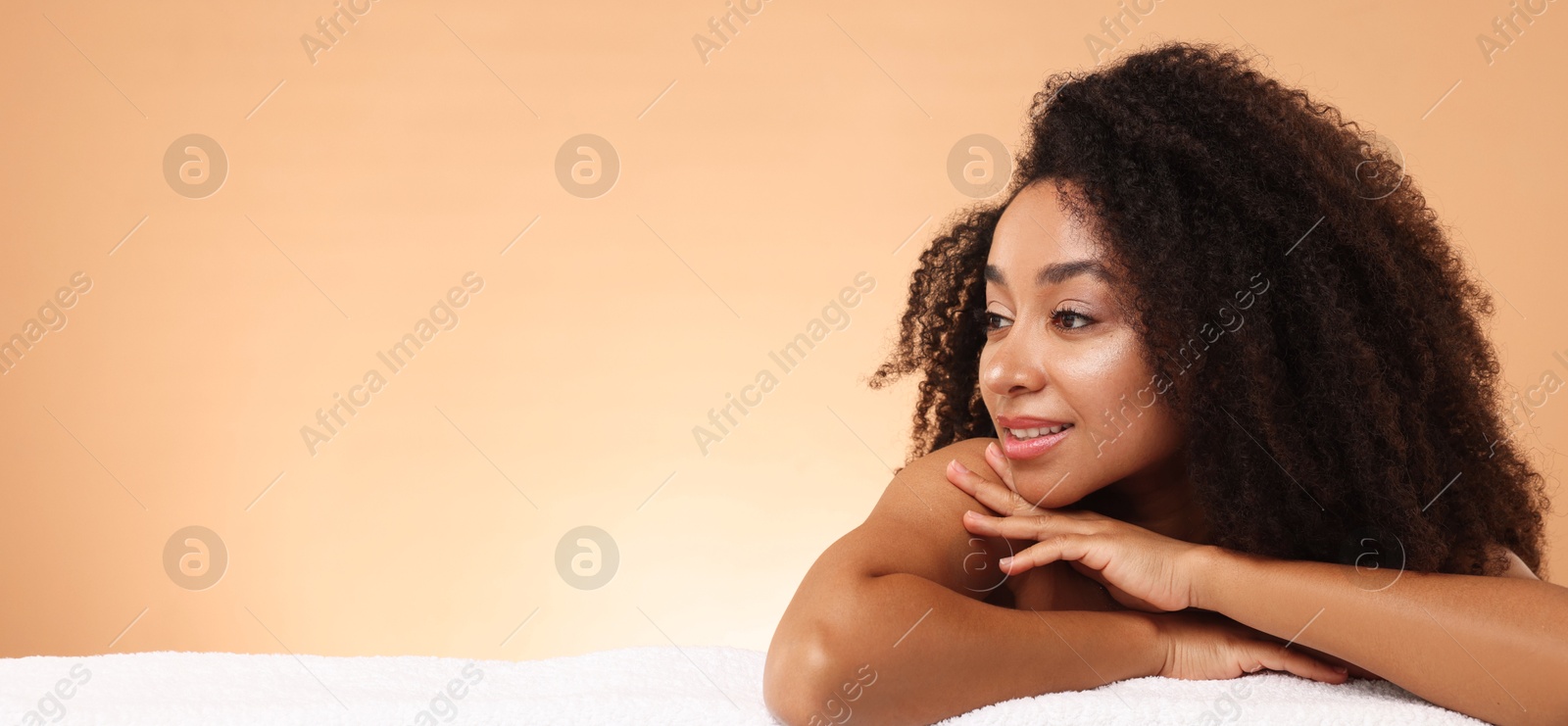 Portrait of beautiful Brazilian woman with towel after spa treatment on beige gradient background. Space for text Photo of Portrait of beautiful Brazilian woman with towel after spa treatment on beige gradient background. Space for text