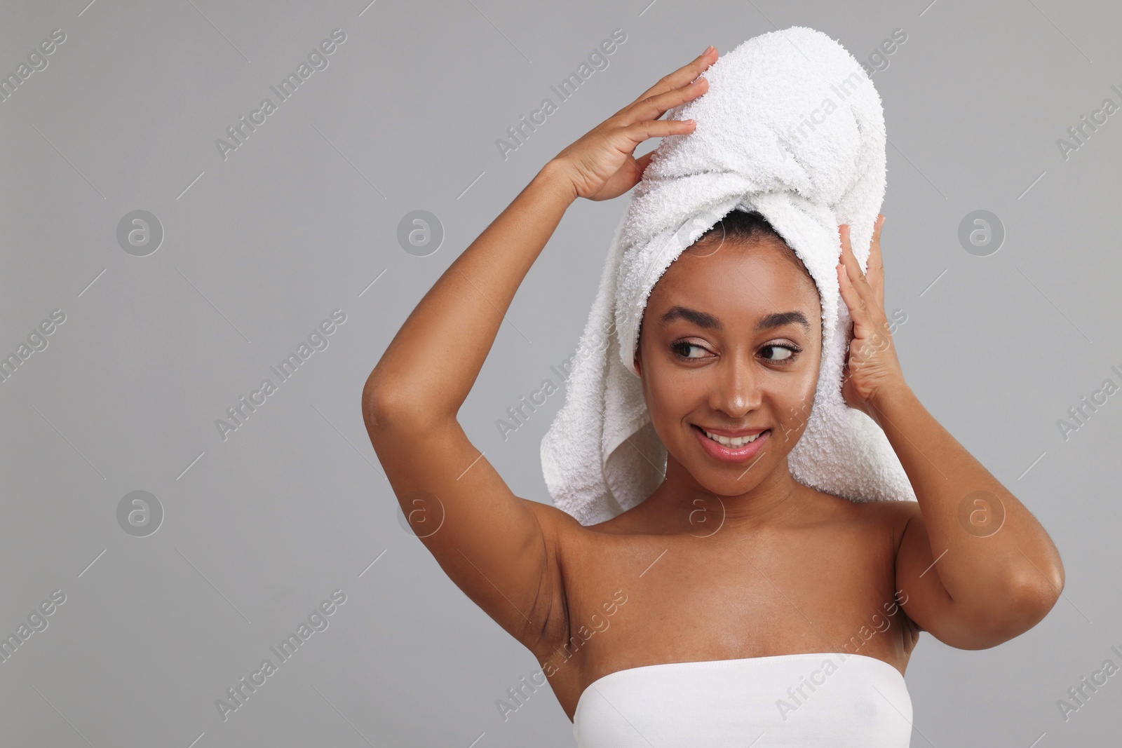 Photo of Portrait of beautiful Brazilian woman after spa treatment on gray background. Space for text