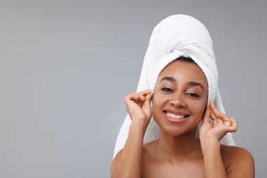 Photo of Portrait of beautiful Brazilian woman after spa treatment on gray background. Space for text