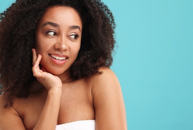 Photo of Portrait of beautiful Brazilian woman after spa treatment on light blue background. Space for text