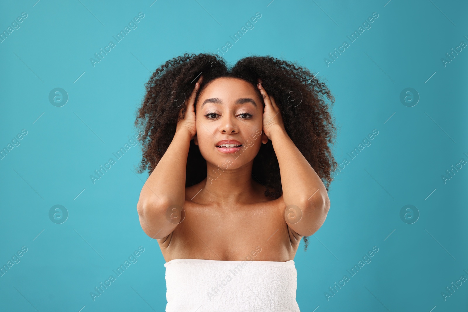 Portrait of beautiful Brazilian woman after spa treatment on light blue background Photo of Portrait of beautiful Brazilian woman after spa treatment on light blue background