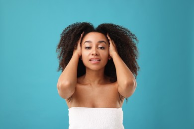 Photo of Portrait of beautiful Brazilian woman after spa treatment on light blue background