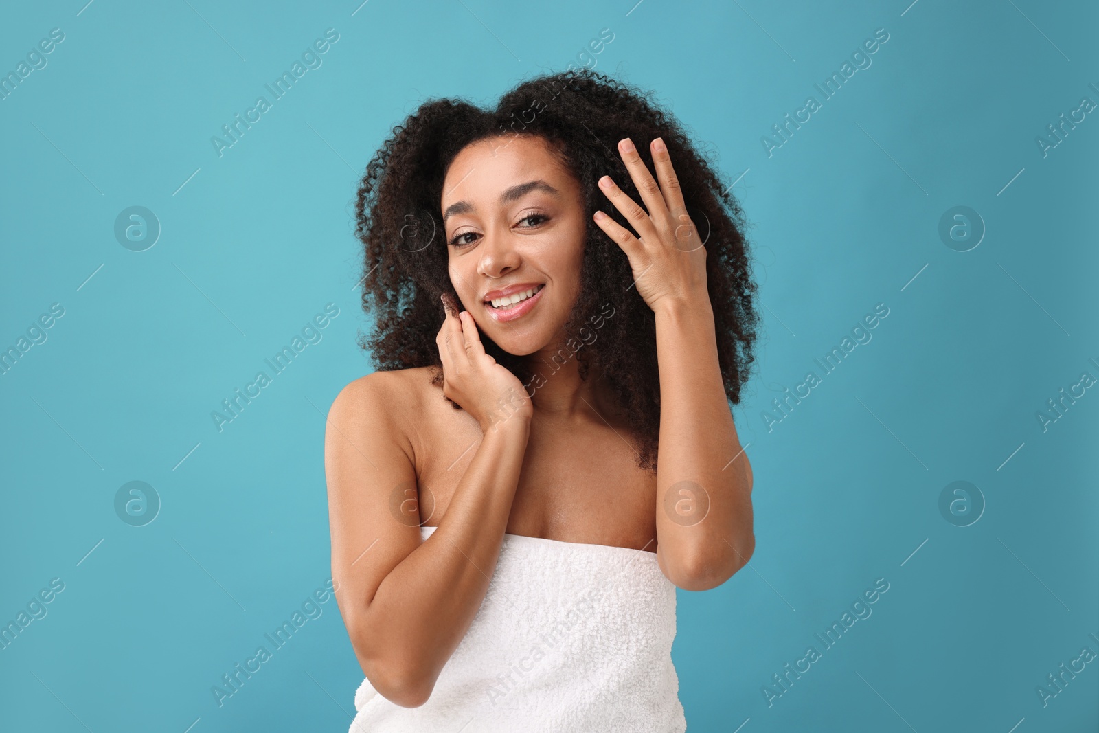 Portrait of beautiful Brazilian woman after spa treatment on light blue background Photo of Portrait of beautiful Brazilian woman after spa treatment on light blue background