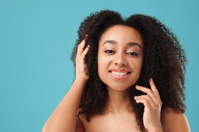 Photo of Portrait of beautiful Brazilian woman after spa treatment on light blue background