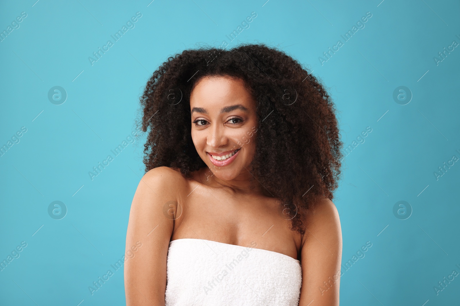 Portrait of beautiful Brazilian woman after spa treatment on light blue background Photo of Portrait of beautiful Brazilian woman after spa treatment on light blue background