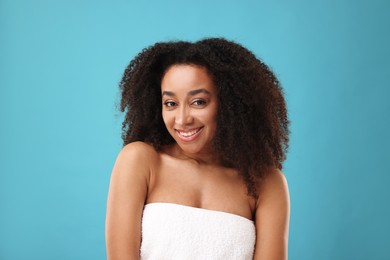 Photo of Portrait of beautiful Brazilian woman after spa treatment on light blue background