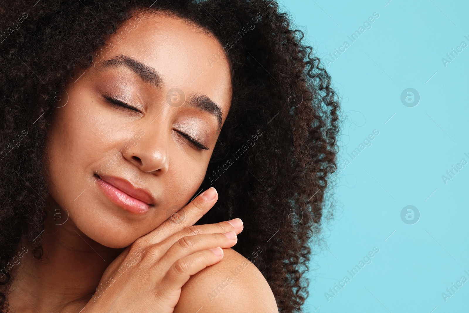 Portrait of beautiful Brazilian woman after spa treatment on light blue background, closeup Photo of Portrait of beautiful Brazilian woman after spa treatment on light blue background, closeup