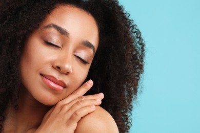 Photo of Portrait of beautiful Brazilian woman after spa treatment on light blue background, closeup