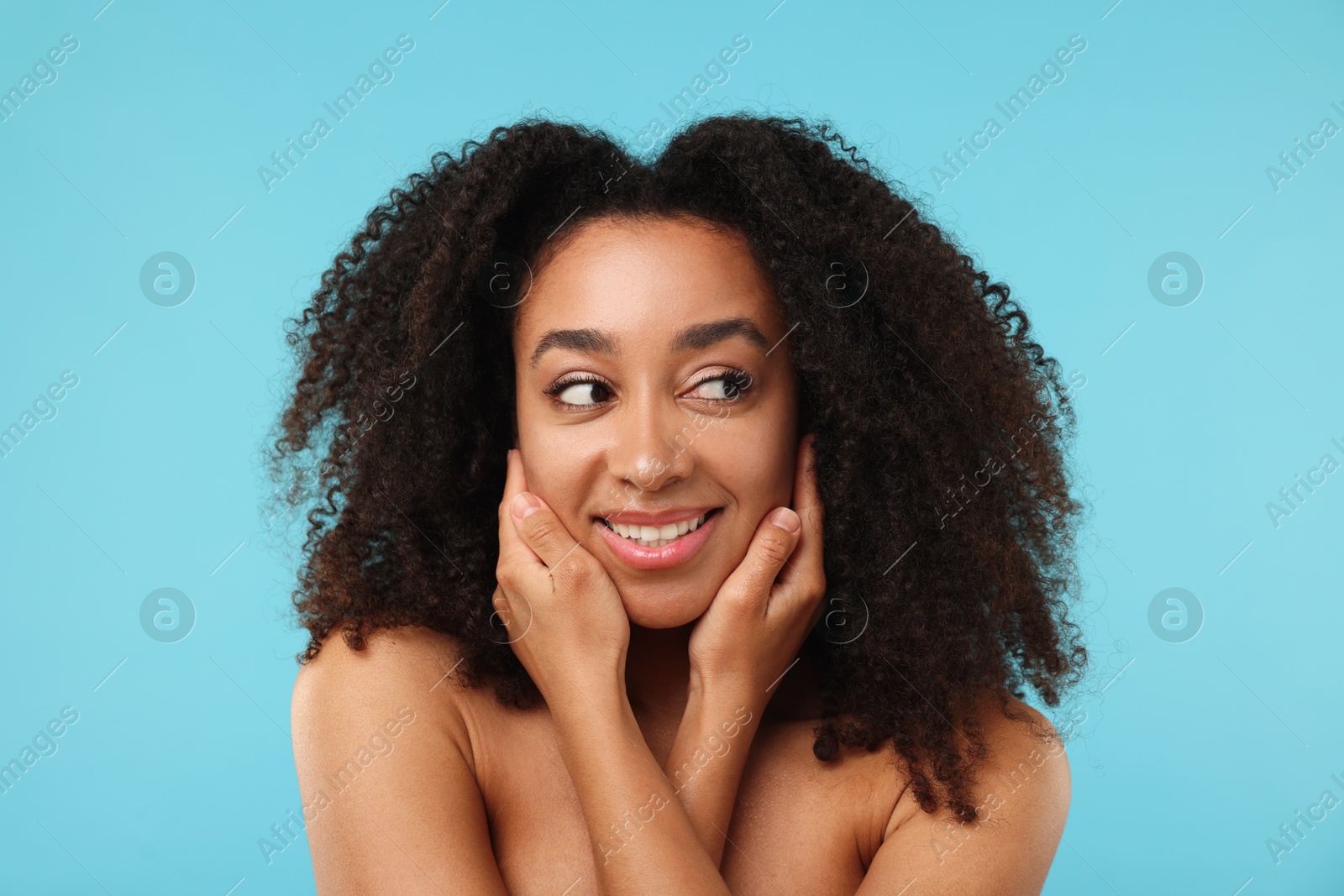 Portrait of beautiful Brazilian woman after spa treatment on light blue background Photo of Portrait of beautiful Brazilian woman after spa treatment on light blue background