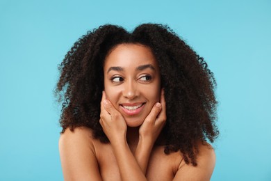 Photo of Portrait of beautiful Brazilian woman after spa treatment on light blue background