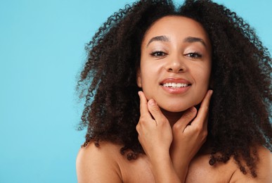 Photo of Portrait of beautiful Brazilian woman after spa treatment on light blue background
