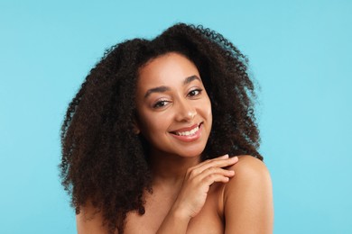 Photo of Portrait of beautiful Brazilian woman after spa treatment on light blue background